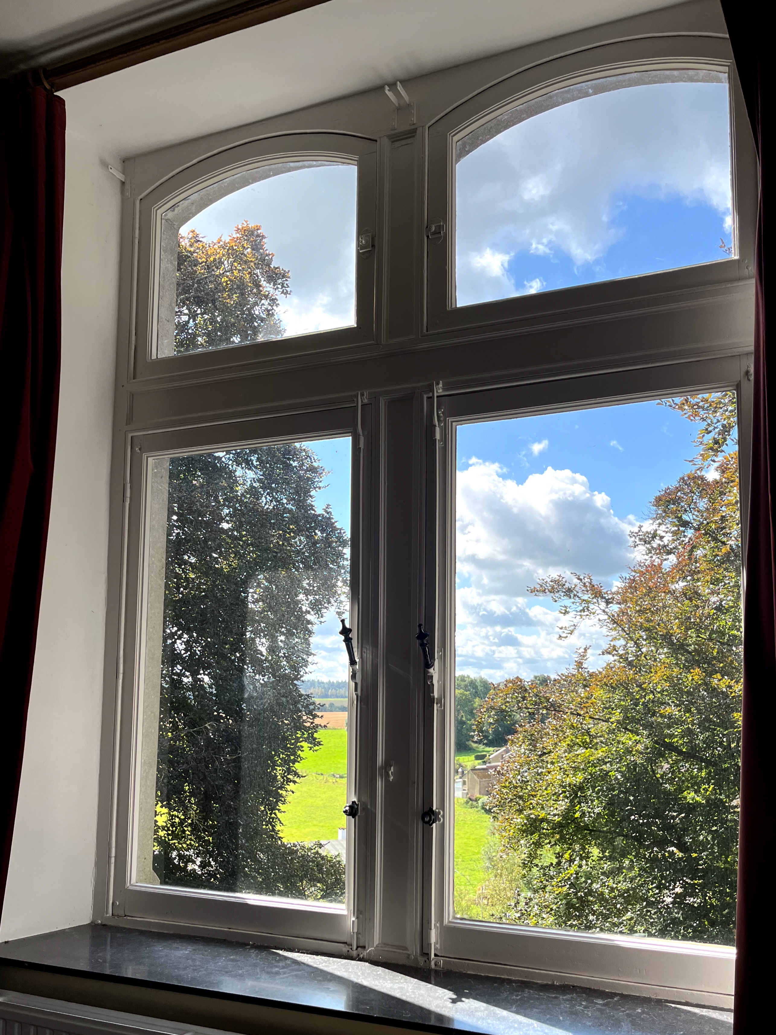 Stunning views over the Ourthe Valley from the window of a cozy room for cyclists and hikers at La Maison Vienvenue.