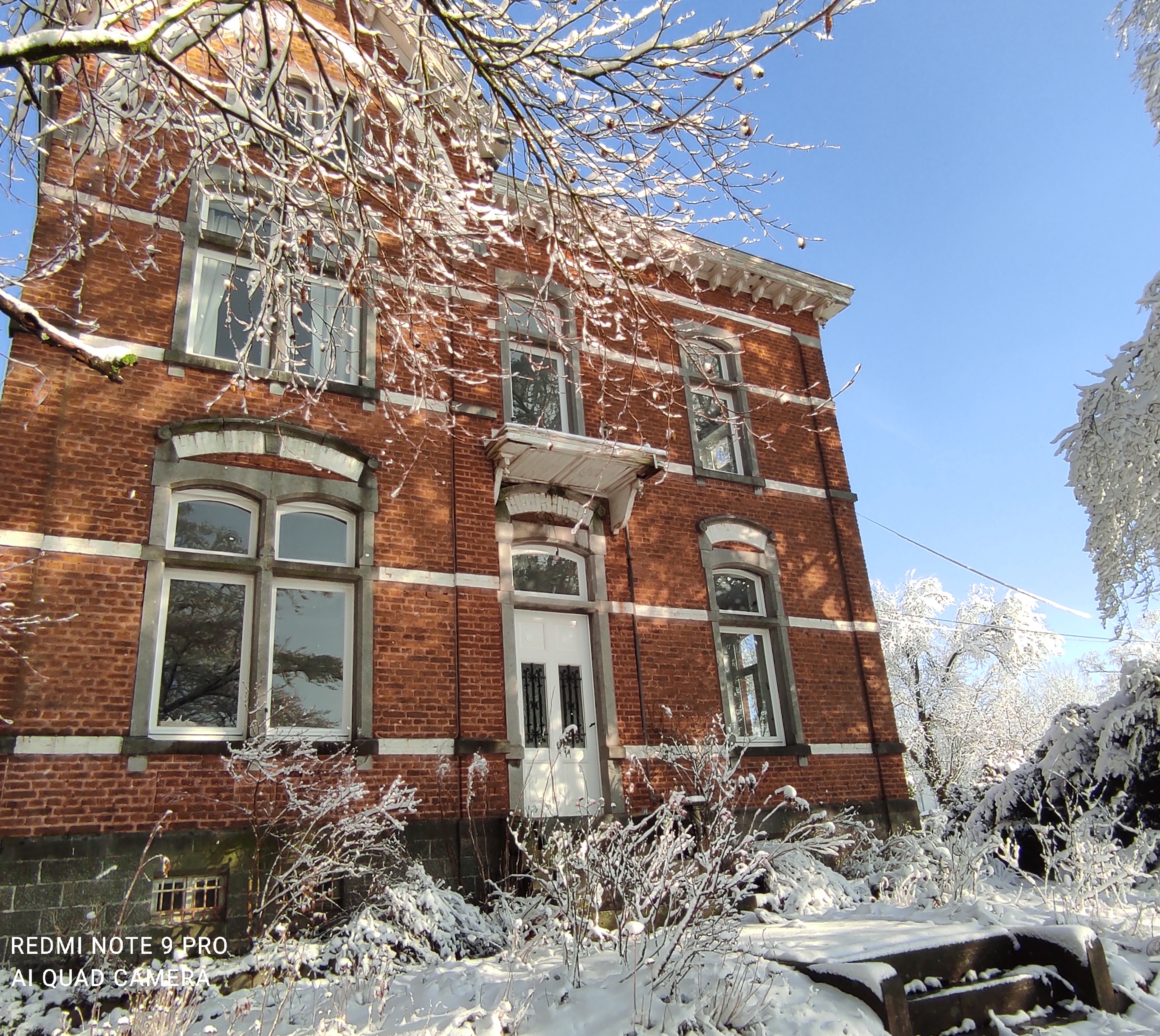 Facade of La Maison Vienvenue, an old manor house and cycling accommodation in the Ardennes, on a snowy winter day