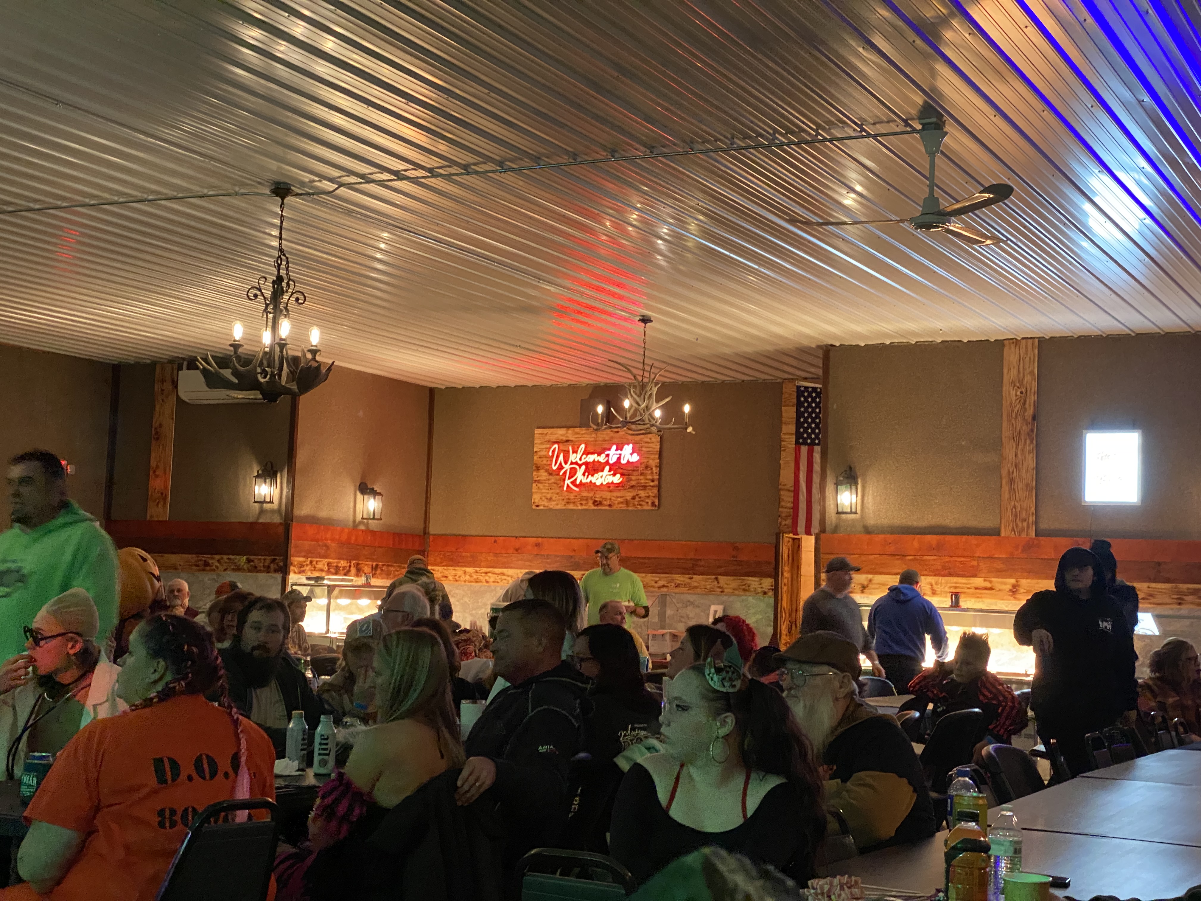 People helping themselves to the Buffet Table and Salad Bars in the Rhinestone Event Center at Best Bear Lodge & Campground.