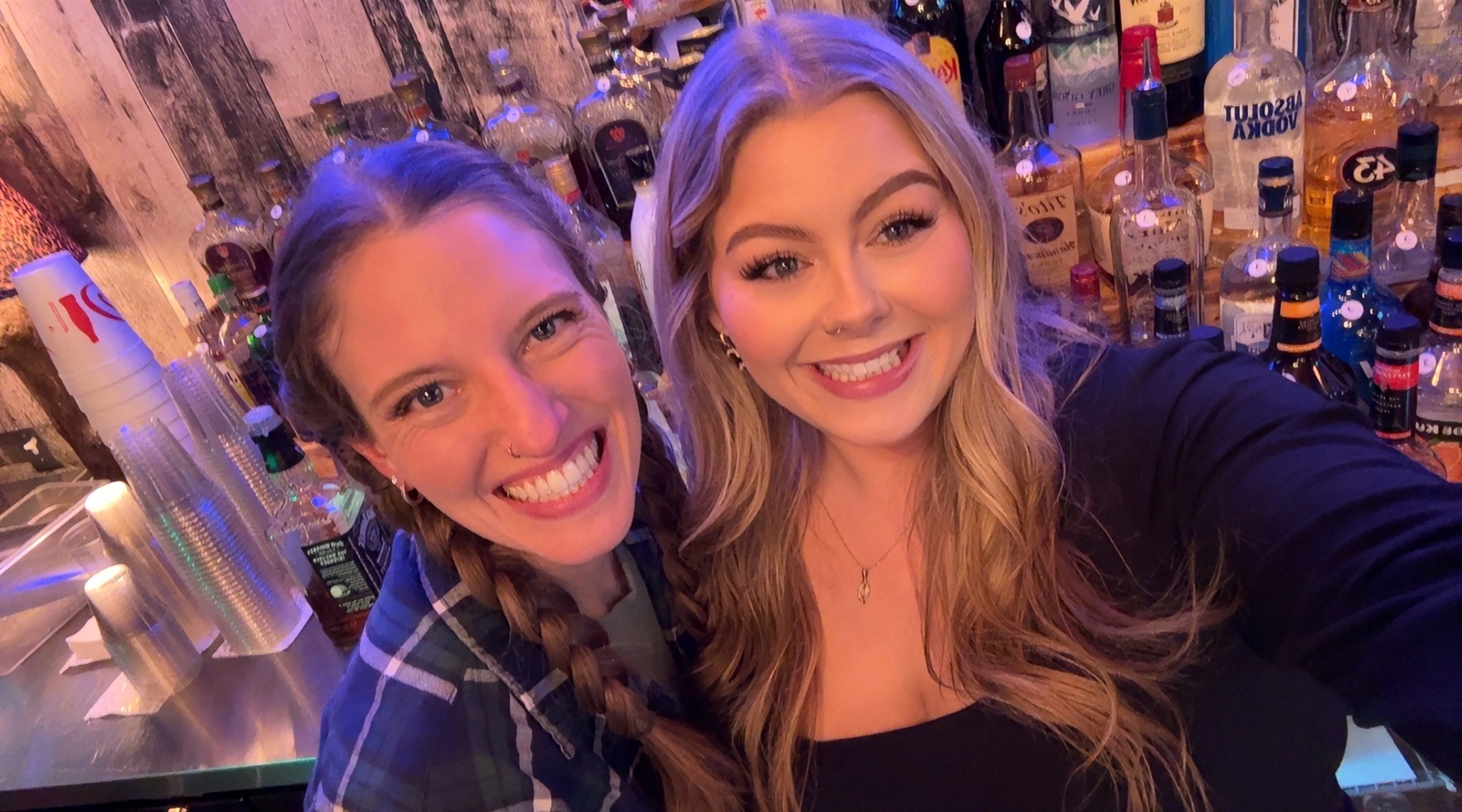 "Bri and Morgan, the Rhinestone Bartenders, serving drinks at a Waylon Hanel country music performance."