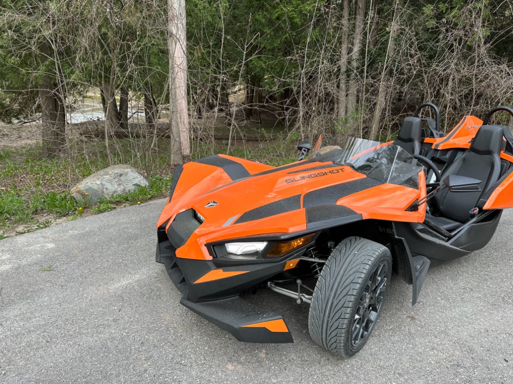 Open-air Polaris Slingshot ready for a river-view drive through the Manistee National Forest
