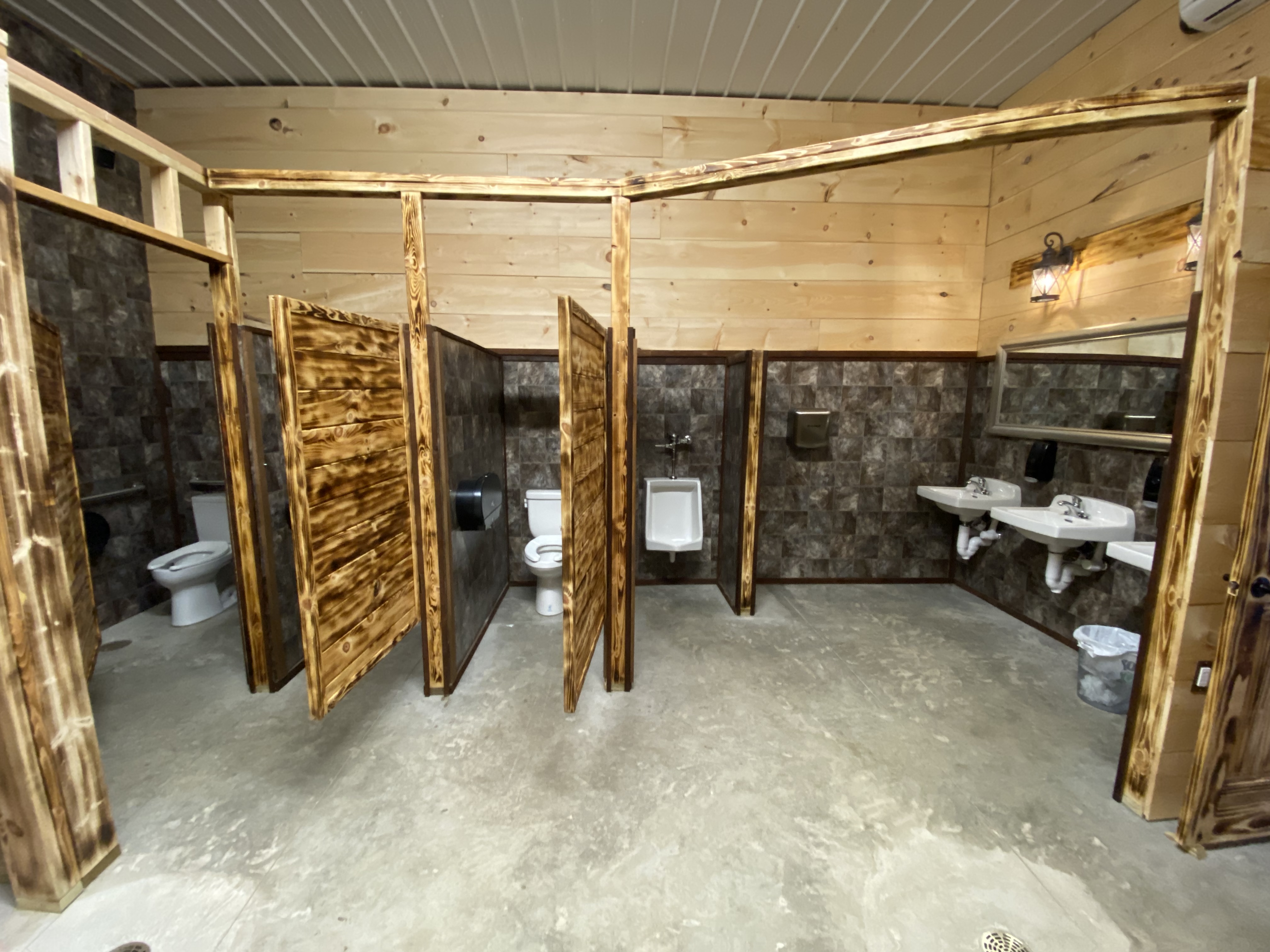 alt="Elegant handicap accessible men's bathroom in the Rhinestone Event Center at Best Bear Lodge & Campground in Irons MI"