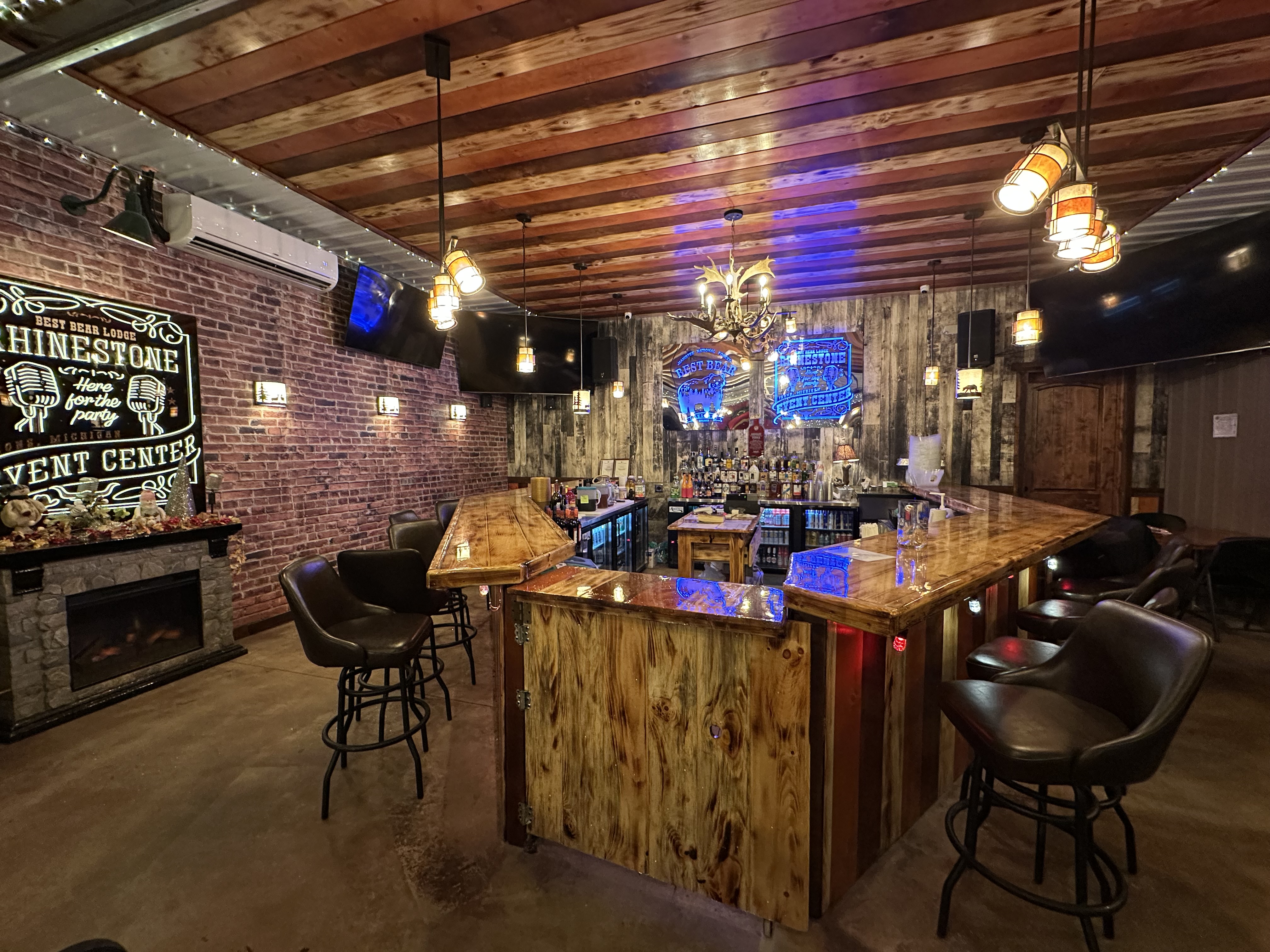 Rhinestone bar sign overlooking beer, wine, and liquor bottles.