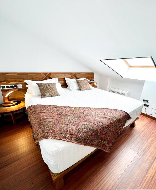 Attic suite with wooden floor and king bed – romantic retreat