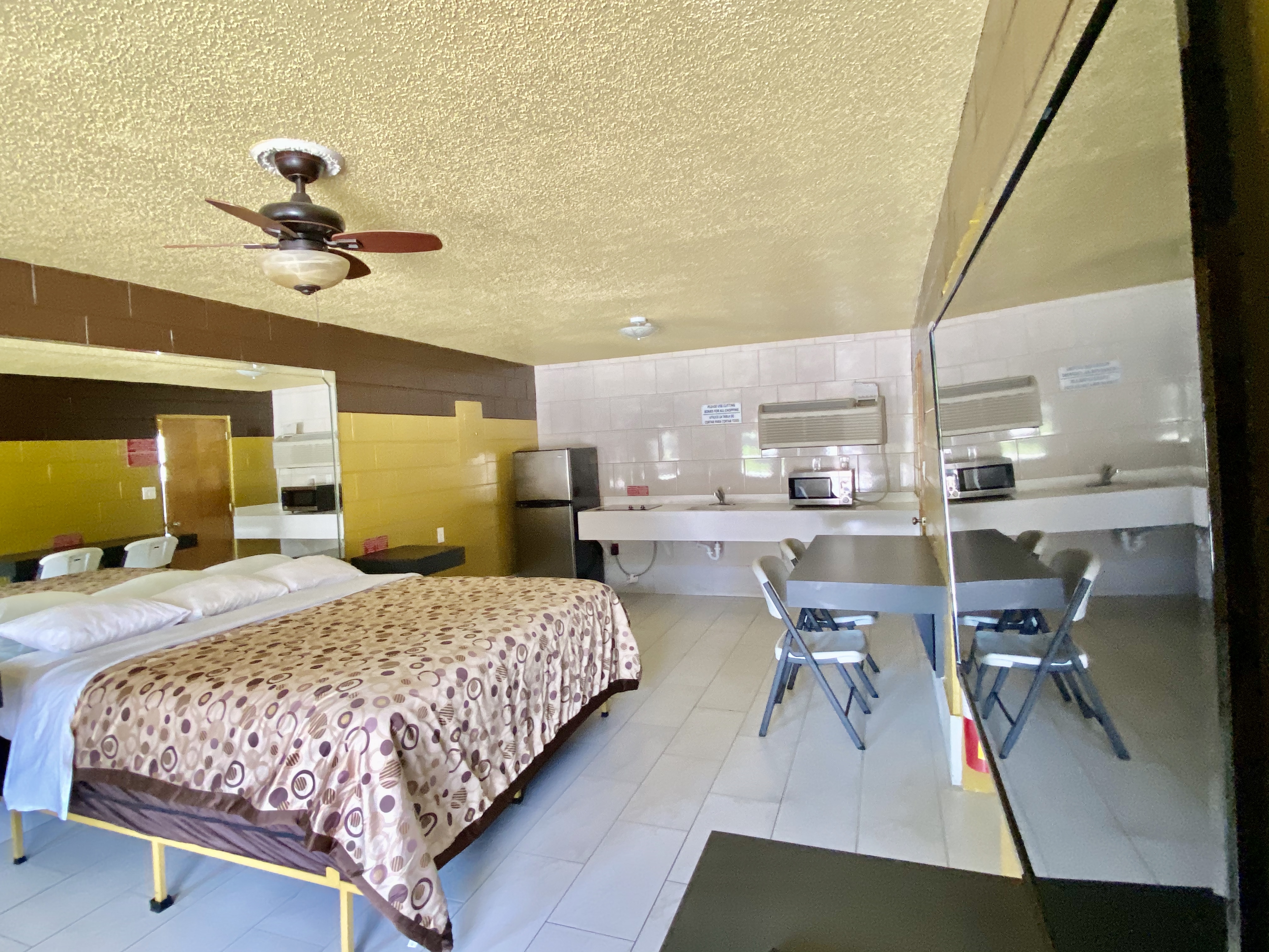 king, king bedroom, kitchenette, refrigerator, microwave, stove top, cooktop, table, chair