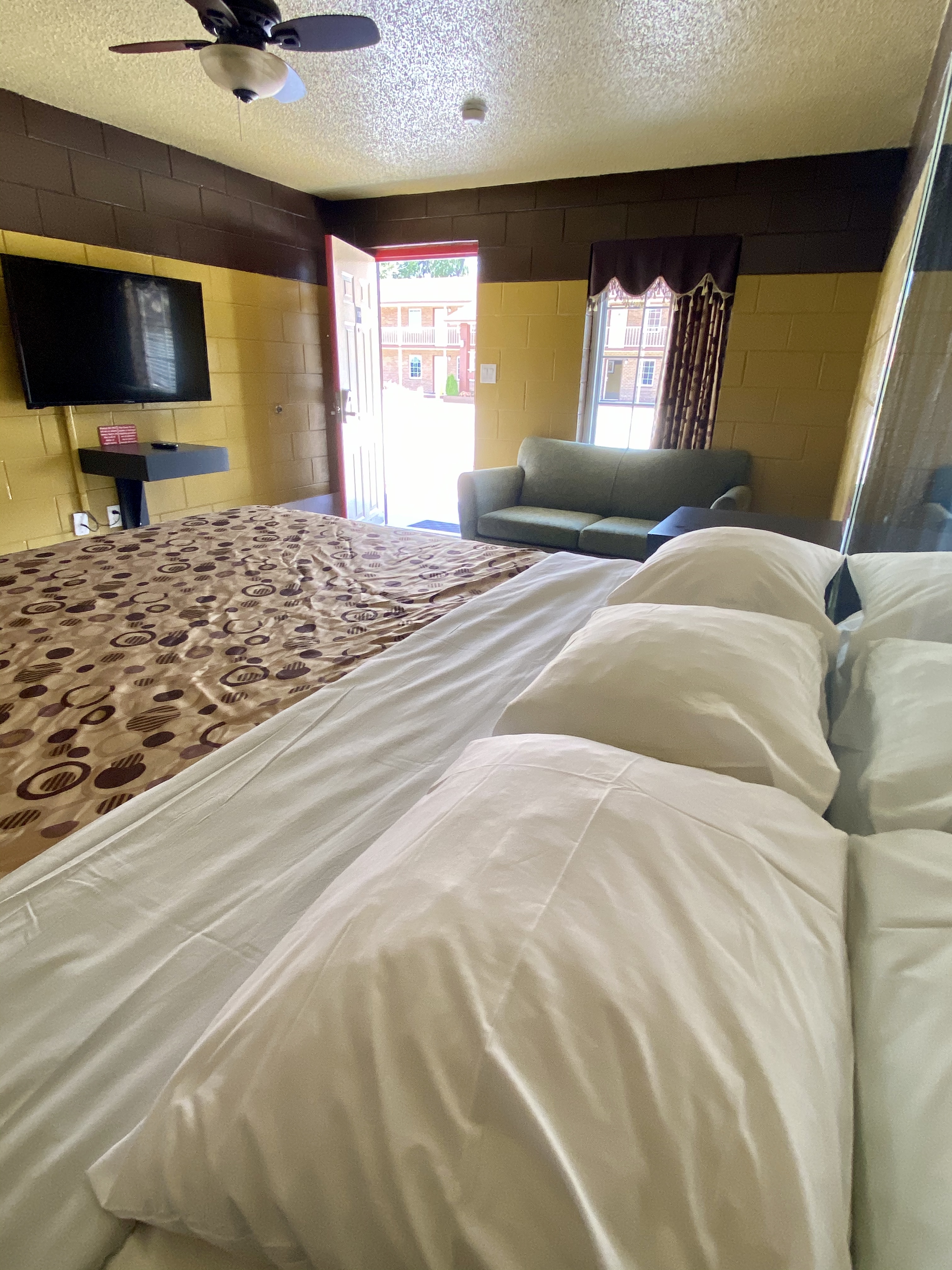 king, king bedroom, kitchenette, refrigerator, microwave, stove top, cooktop, table, chairs, bed, private room