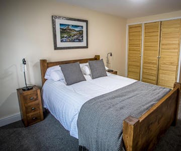 cosy bedroom with oak furniture and large wardrobe space