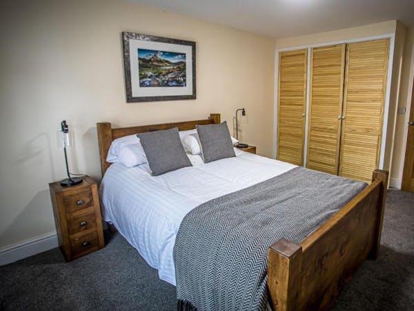 cosy bedroom with oak furniture and large wardrobe space