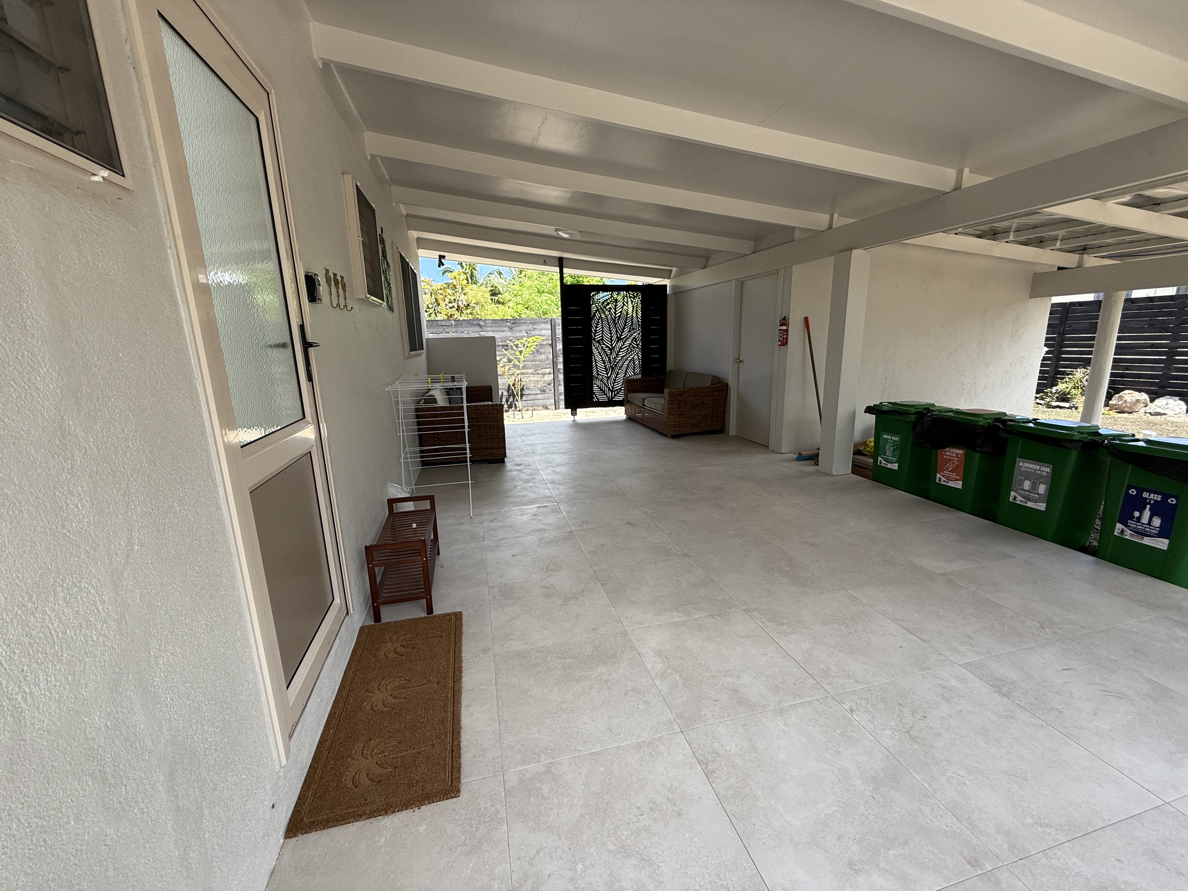 Back Verandah and Laundry/storage room through the door by the rubbish bins.