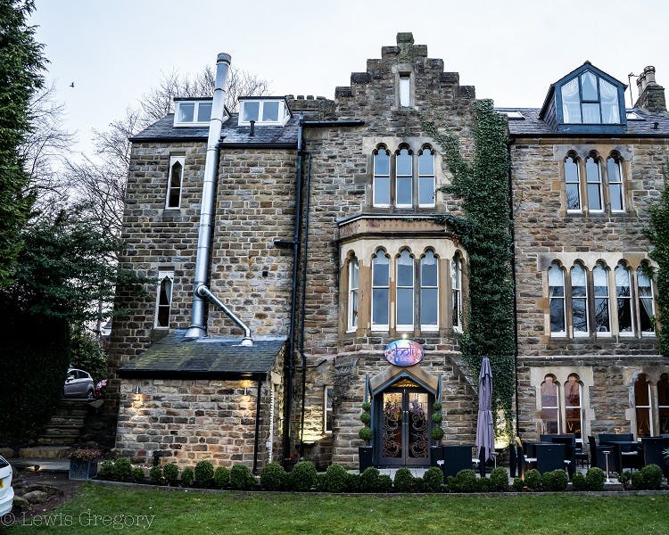 Main building for Farnley Tower, restaurant entrance with patio , garden and views