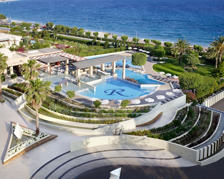 Areal view of main entrance area, pool and beach