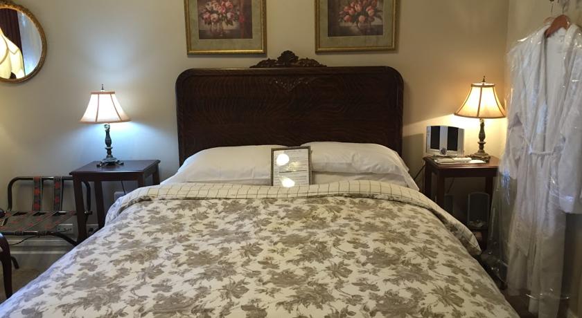 Tiger-oak headboard of bed in Tuolumne Room