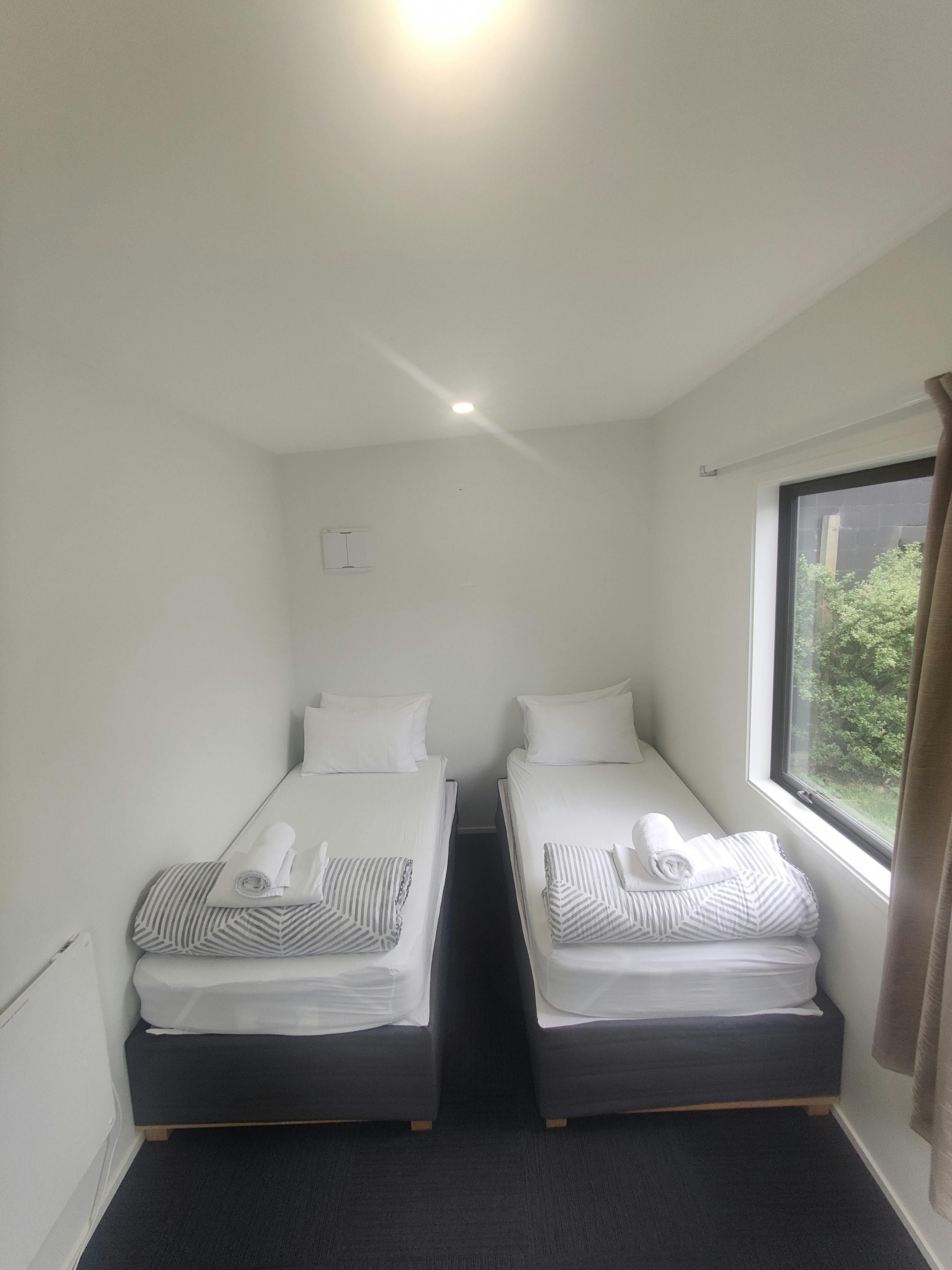 Cabins, twin single and double beds at QBox Campground Queenstown