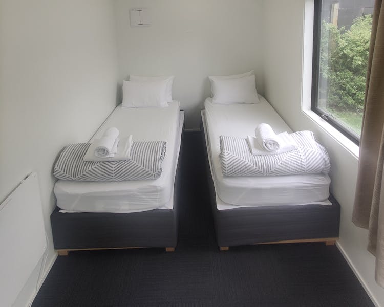 Cabins, twin single and double beds at QBox Campground Queenstown