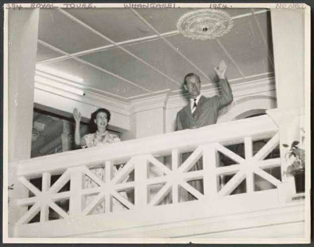 Queen Elizabeth and Prince Phillip waving from the balcony room 1953