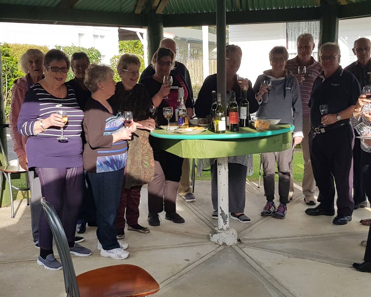 Guests enjoying a wine in a pergola