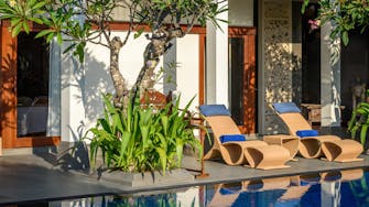 PRIVATE VILLAS OF BALI - Villa Frangipani - comfortable deck chairs by the swimming pool to relax and soak up the sun.