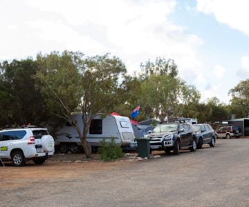 "Powered caravan sites showing caravans and cars"