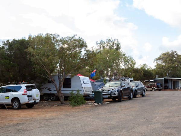 "Powered caravan sites showing caravans and cars"