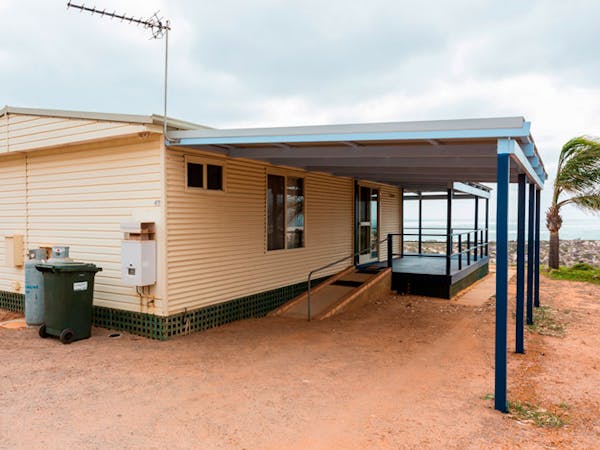"Back and side view of two bedroom beach cottage 47 with carport"