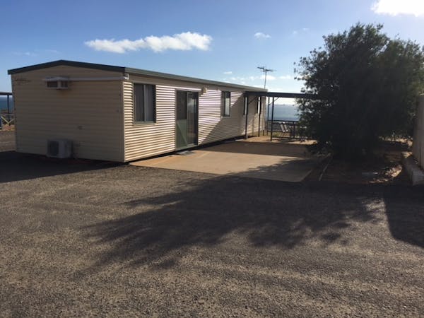 "Out side view of two bed room park home 45 car park and patio area with ocean views"