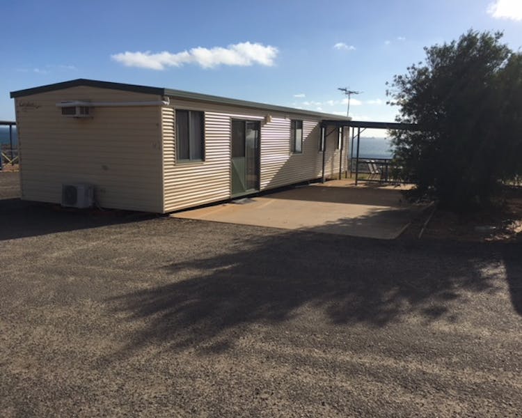 "Out side view of two bed room park home 45 car park and patio area with ocean views"