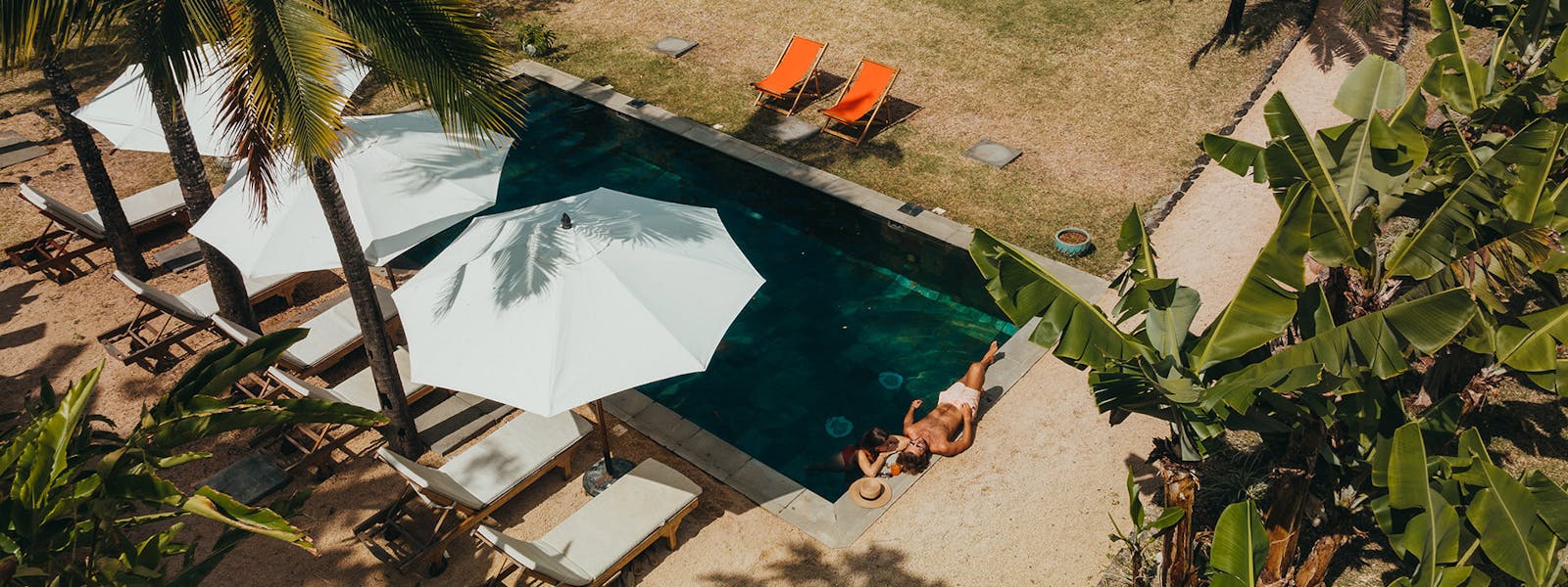 Couple enjoying sunbath on the edge of pool at Kazalala, Hosted Bed and Breakfast Mauritius