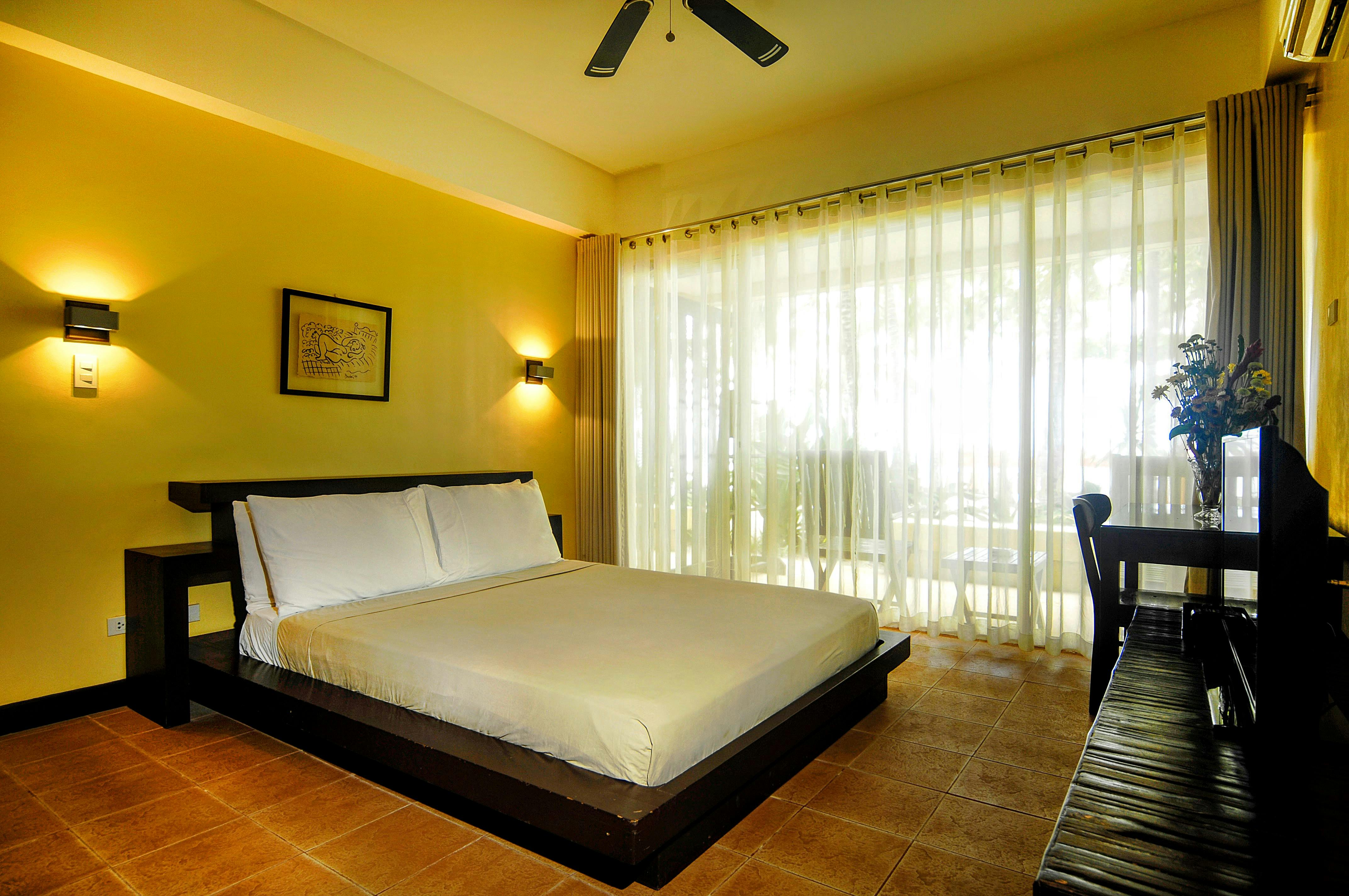 Tagbanua bedroom with closed thin blinds - 1 bedroom absolute beachfront apartment at Boracay SandCastles The Apartments.