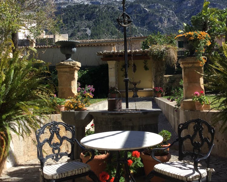 The Salvia well and font with the Tramuntana Mountains in the background