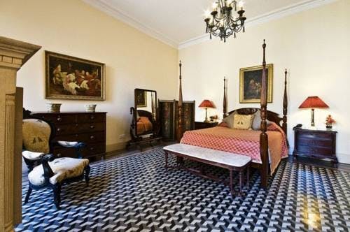 The four poster bed and ornate tile flooring of the 4 roomed Salvia Superior Suite