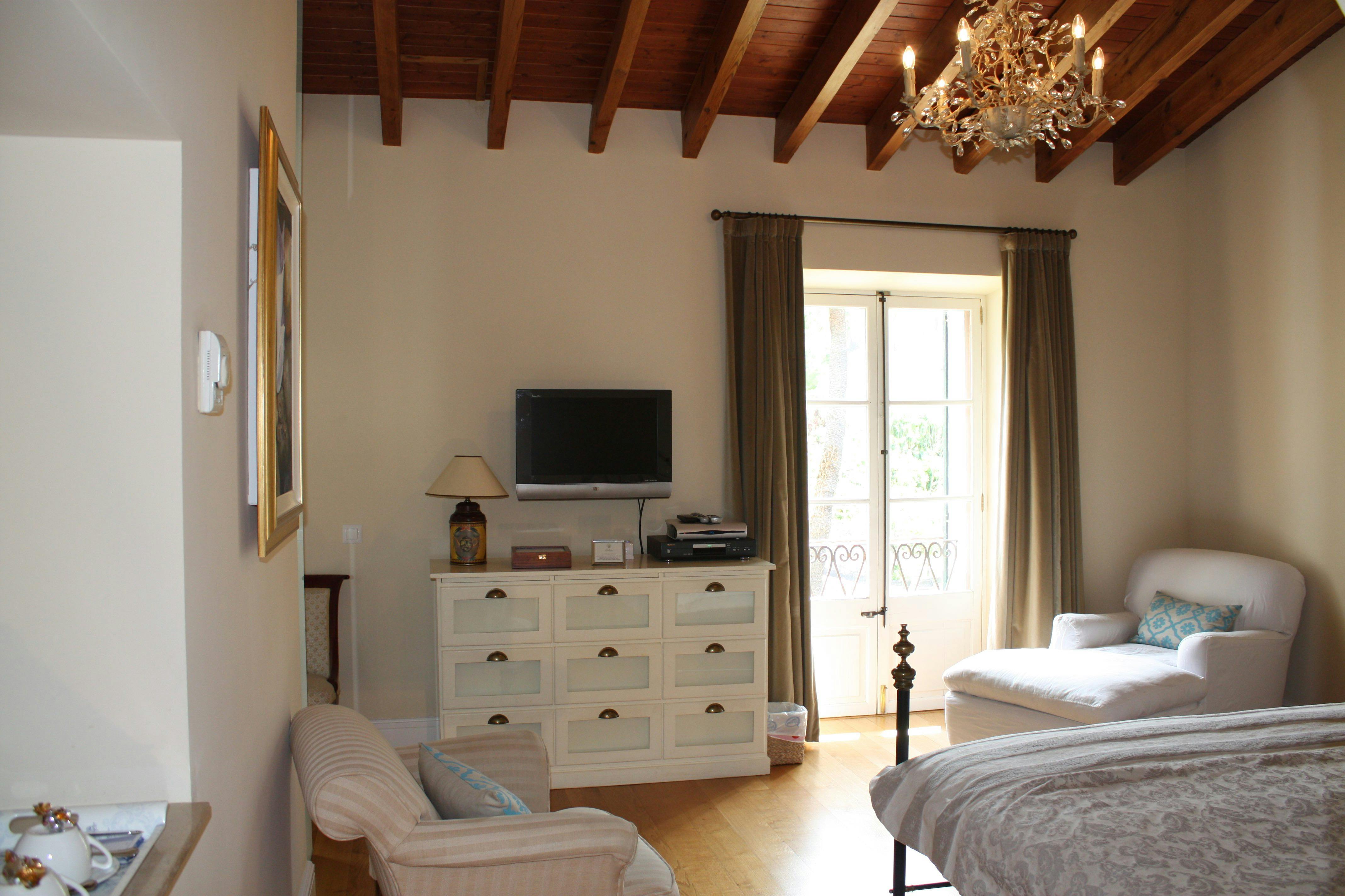 A view of the Deia Junior Suite looking towards the french windows