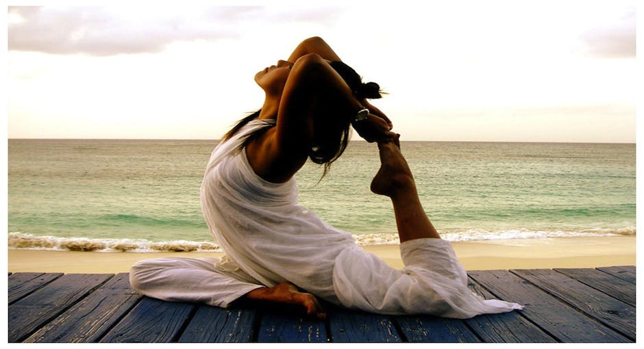 Femme qui fait du yoga au bord de la mer