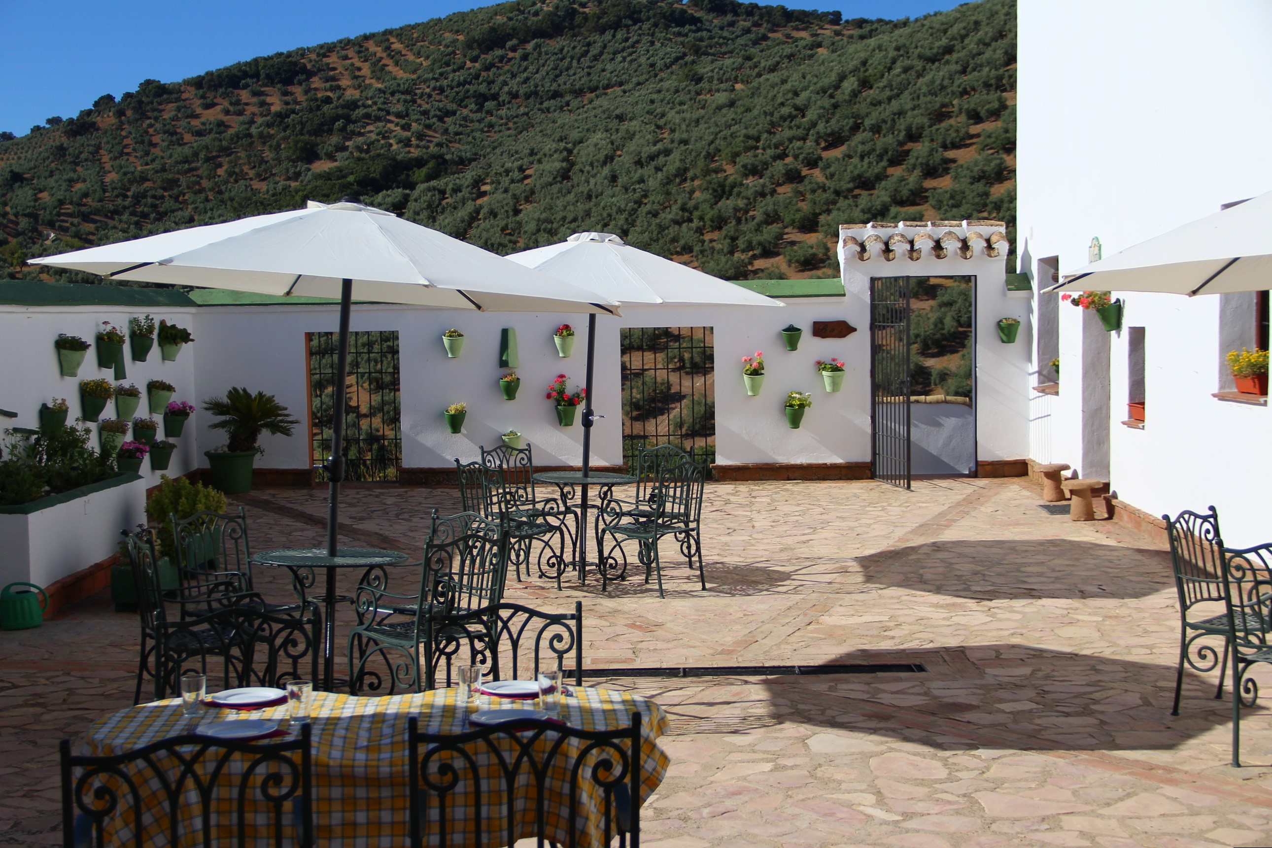 Courtyard patio with traditional tiled flooring, wooden beams, and rustic seating
