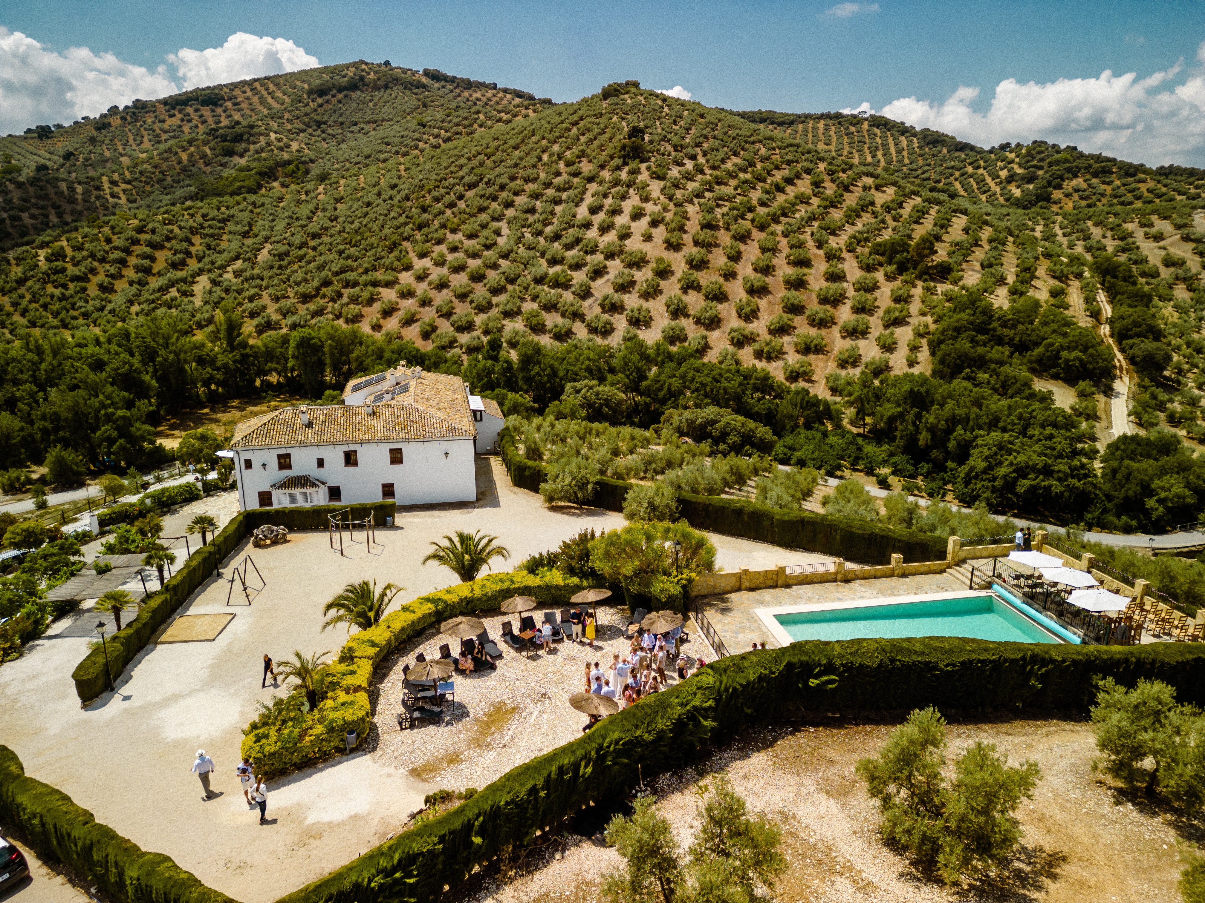 Image of the rustic 18th‑century Andalusian farmhouse façade framed by olive trees
