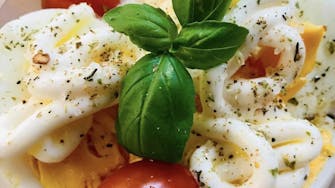 Simple breakfast pot of Egg, mayo, cherry tomatoes and basil