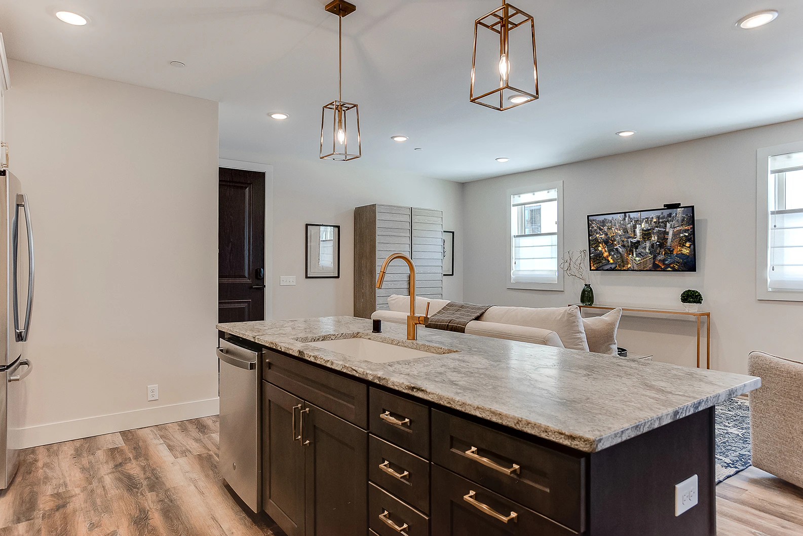A modern open-plan living space with kitchen and living area