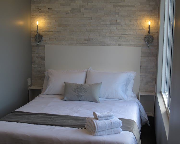 Soft and romantic. Stone headboard adds to the glamour of this room