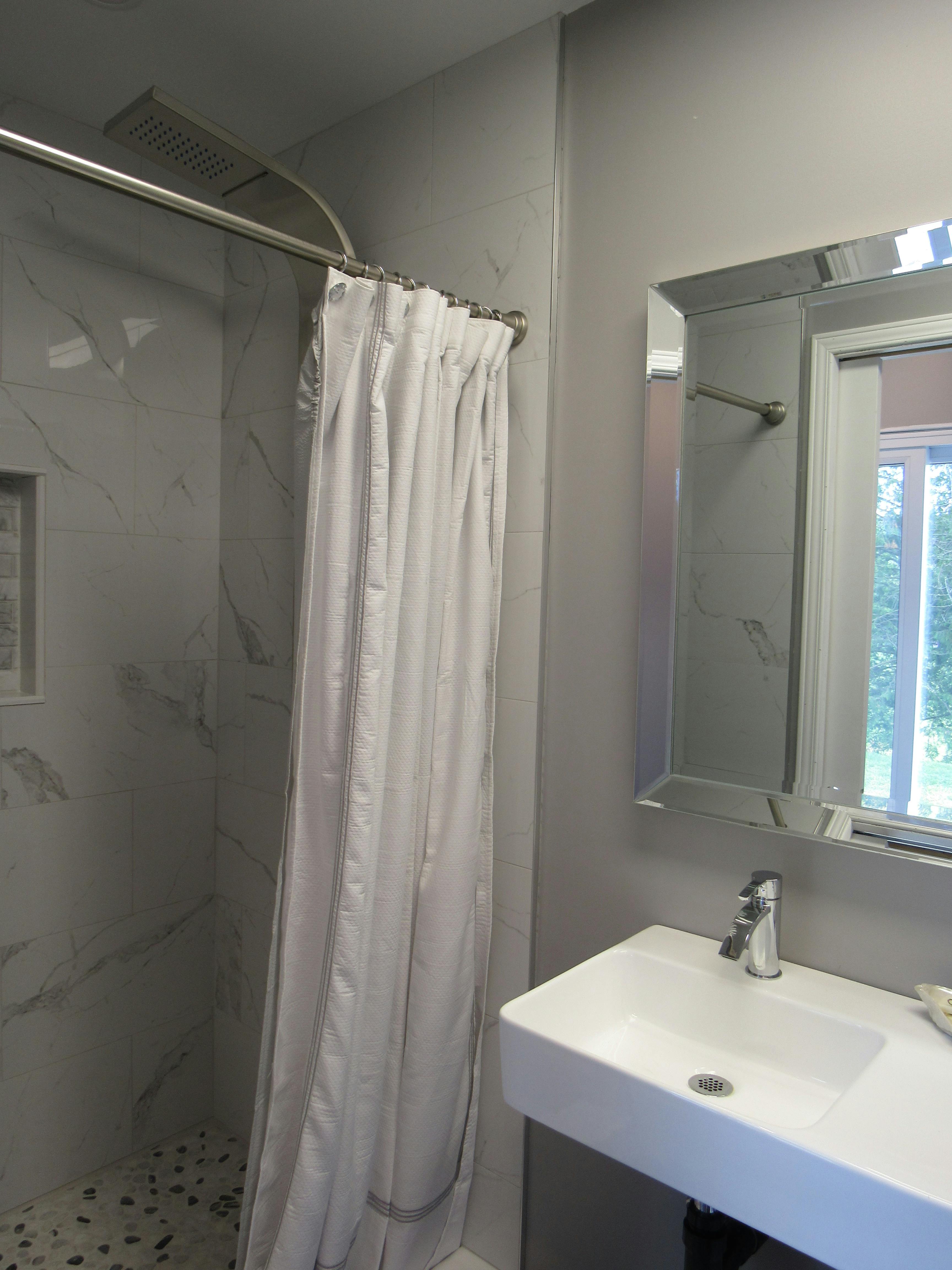Elora Suite bathroom. Walk in shower with full body shower panel.