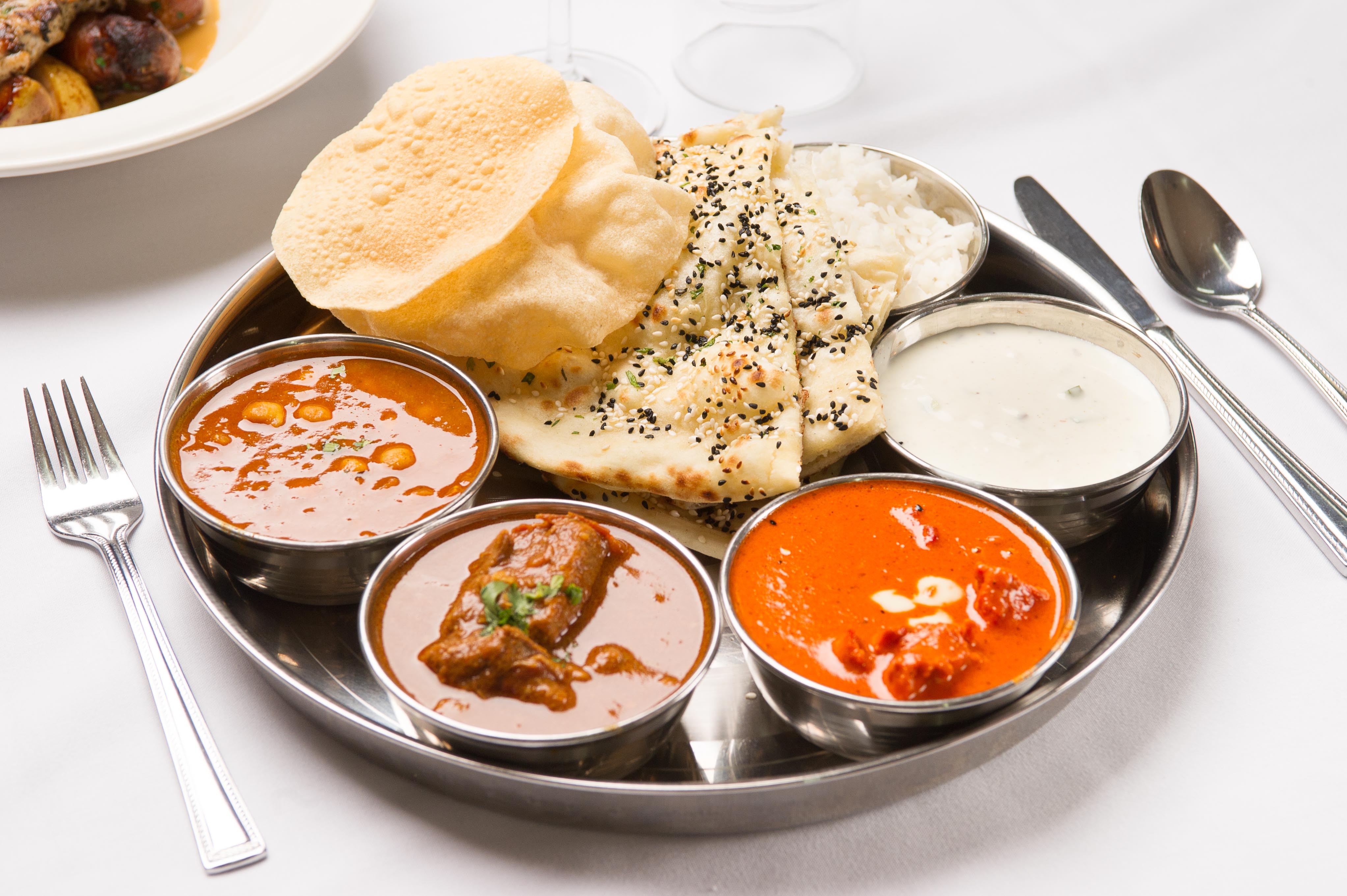 Indian cuisine: A flavorful platter with curry, naan, rice, and more.