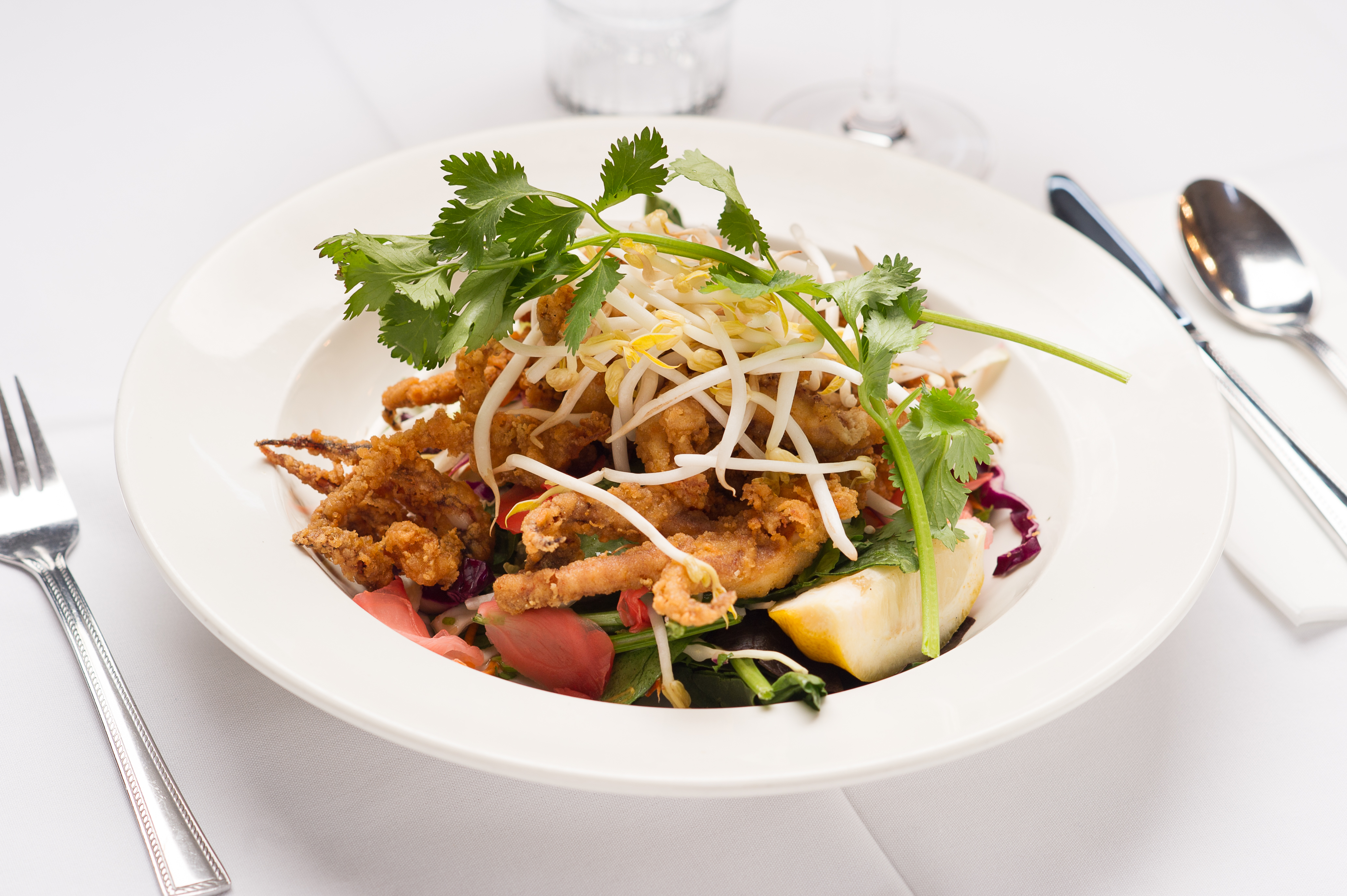 Crispy fried calamari rings. Served on a bed of greens. Bean sprouts, cilantro, lemon.