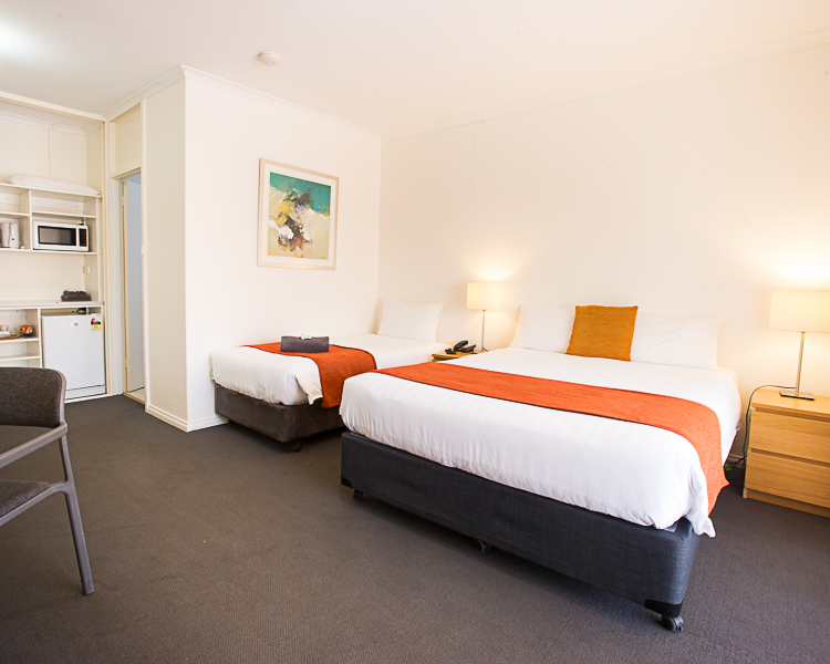 Comfortable room: 1 double, 1 single bed, amenities for small groups/families.