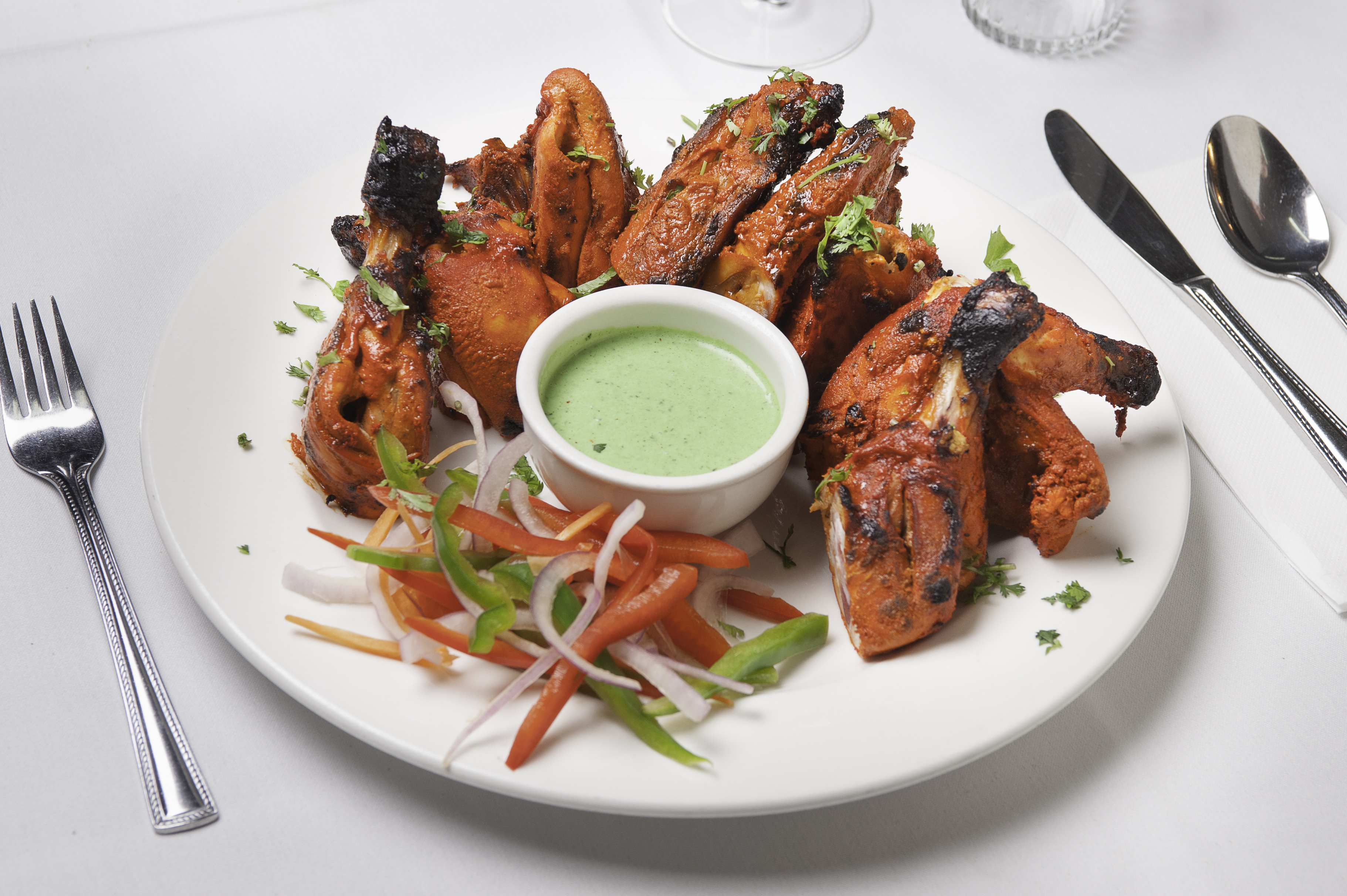 Succulent tandoori chicken, vibrant veggies, and refreshing mint sauce.