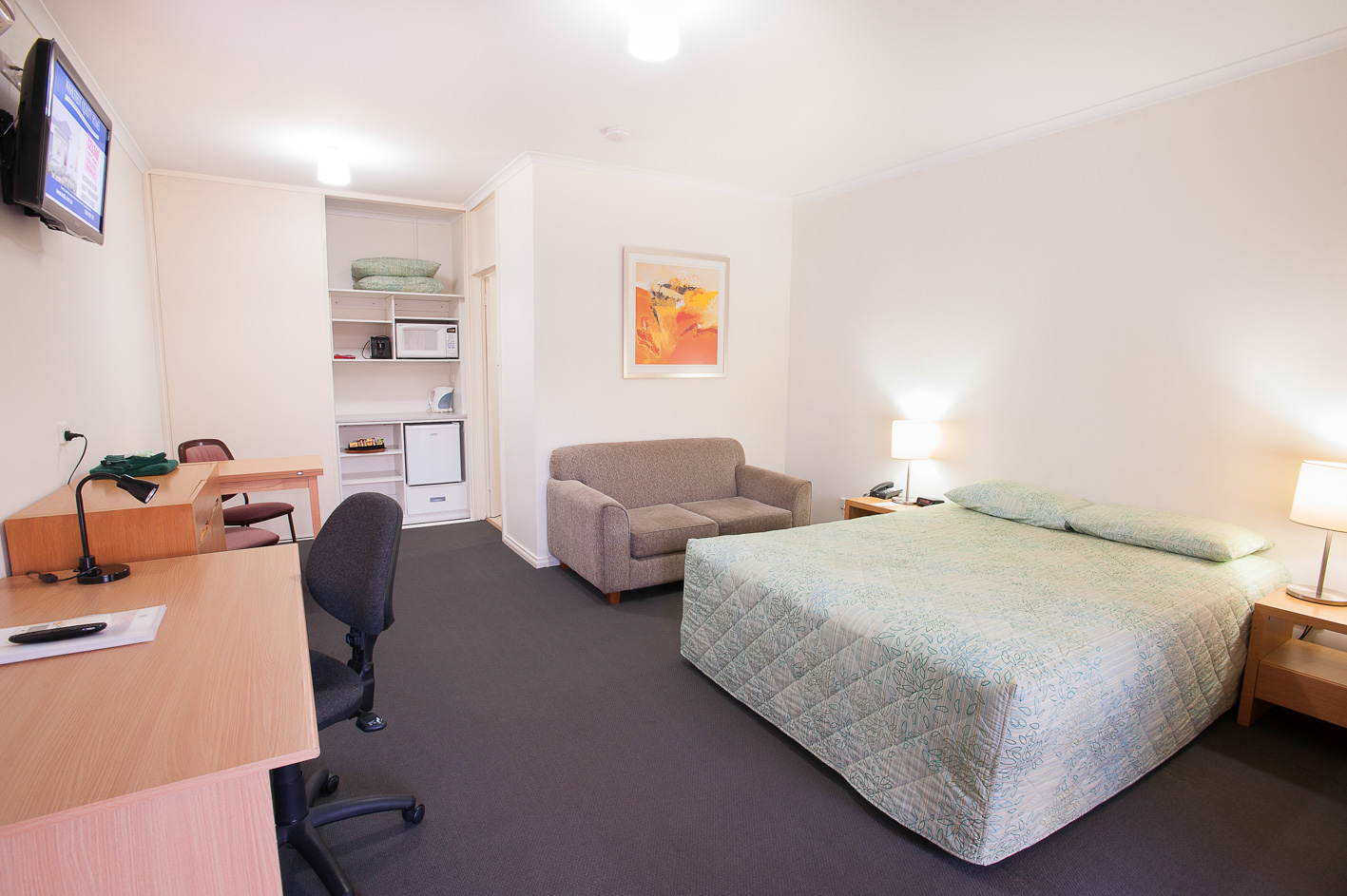 Clean motel room with double bed and essential features.