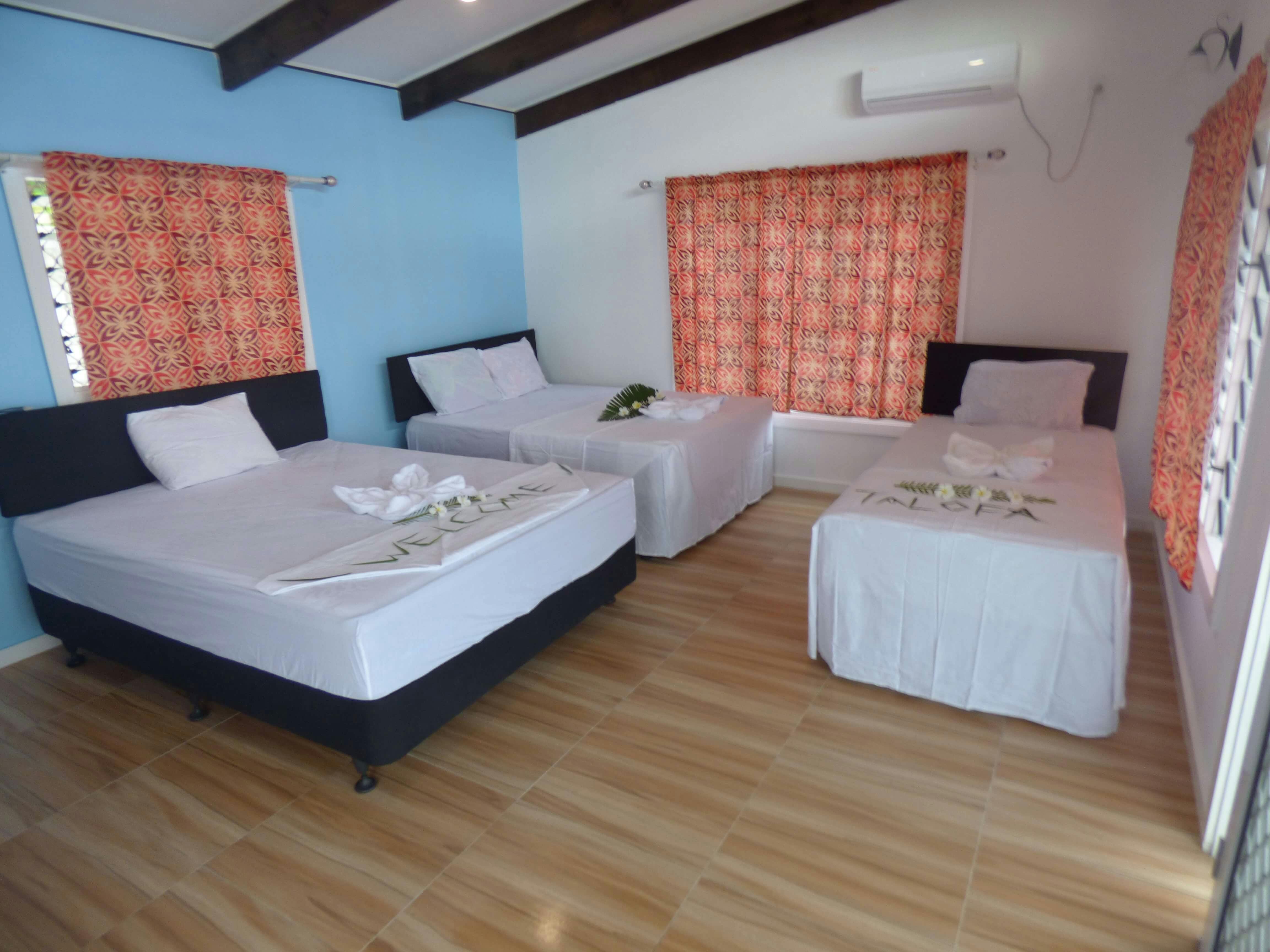 Bed room of Villa at Level 2 featuring 1 Queen Size bed, 1 Double bed and a Single bed.
