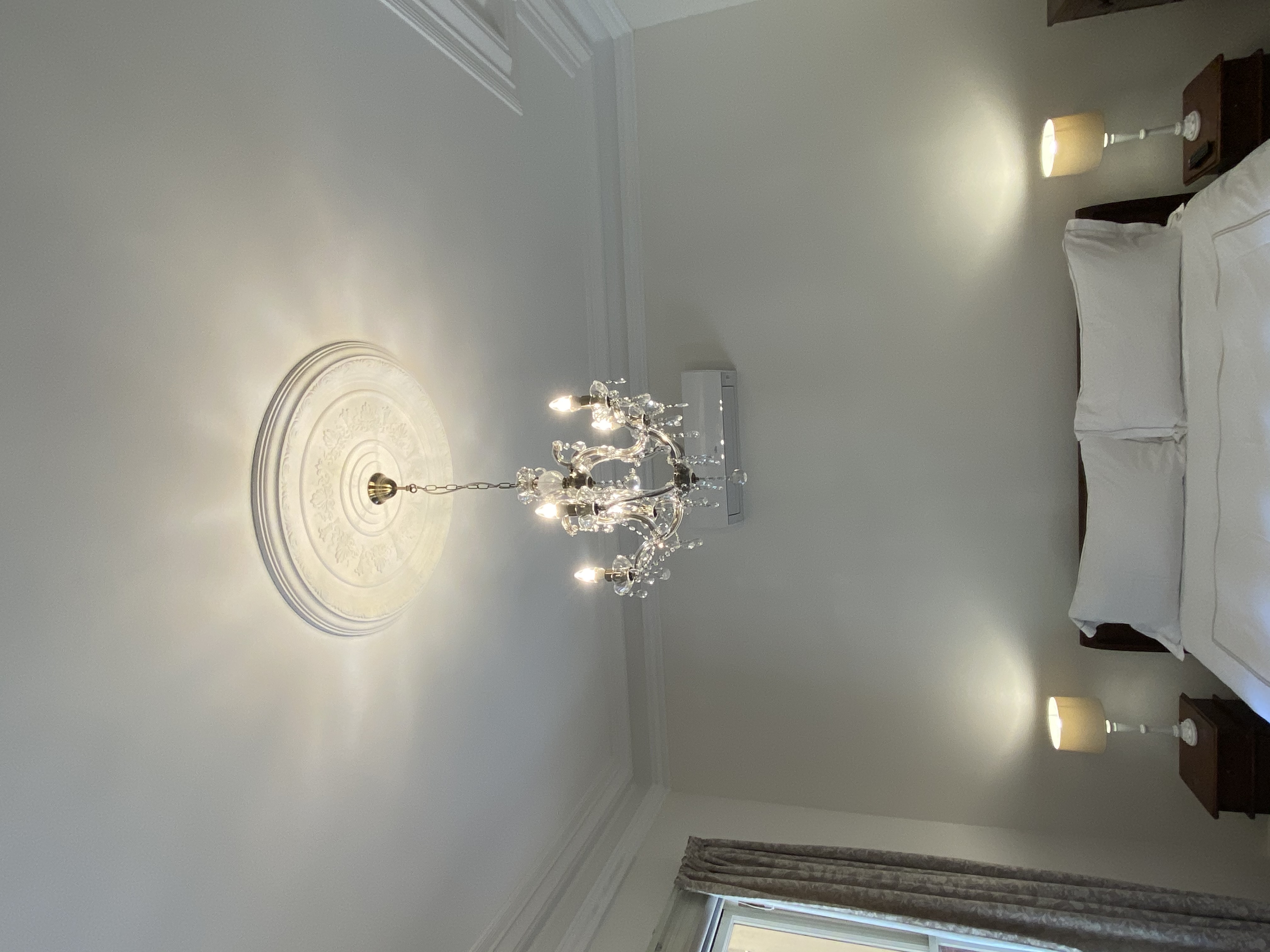 Homestead Room 1 with high ceilings and ornate moldings.
