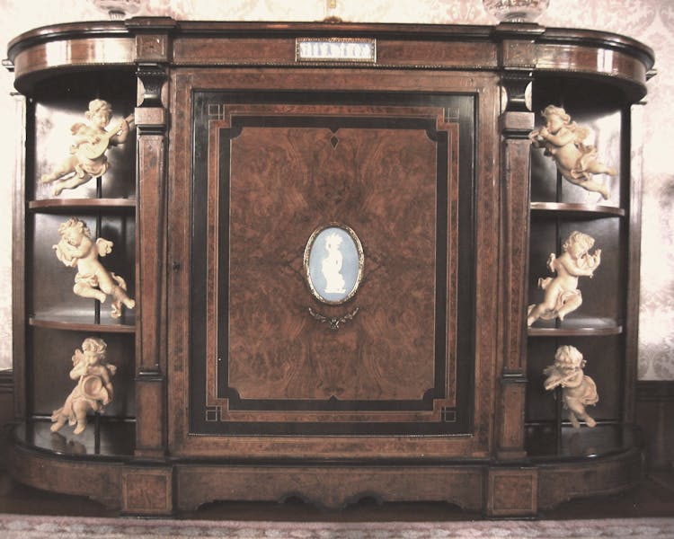 Cabinet in Music Room with six hand carved wood angels playing various instruments.