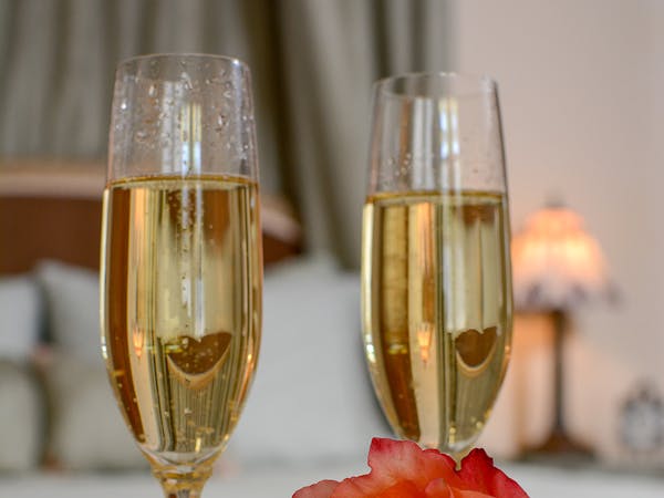 Photo of champagne and a rose.