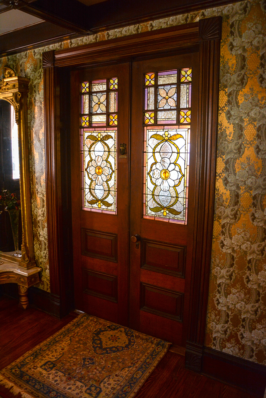 Doors into front parlor with Tiffany glass panels.