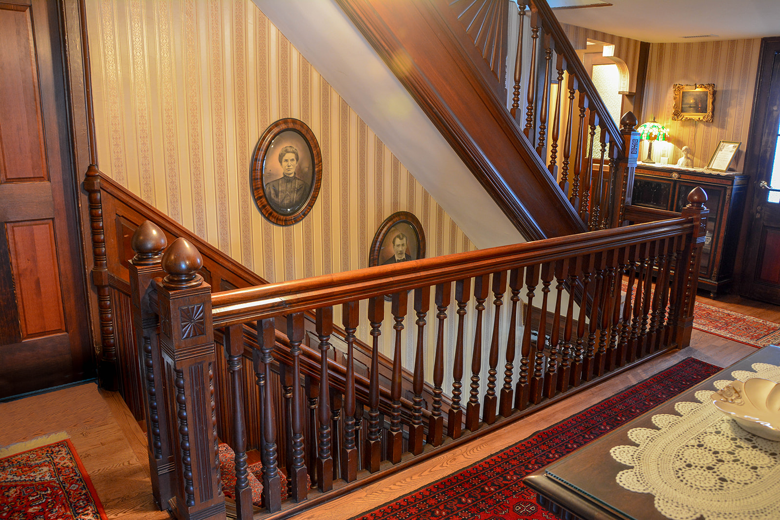 Staircase showing 19th century portraits of man and wife.