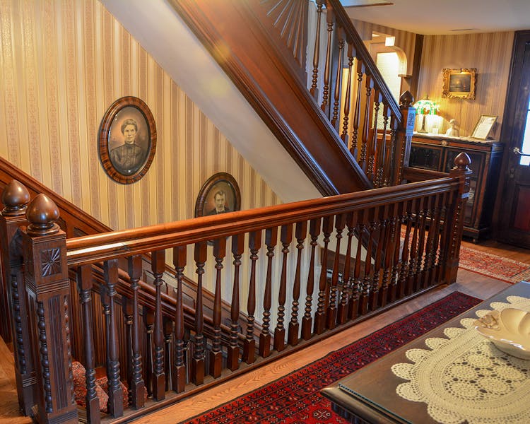 Staircase showing 19th century portraits of man and wife.
